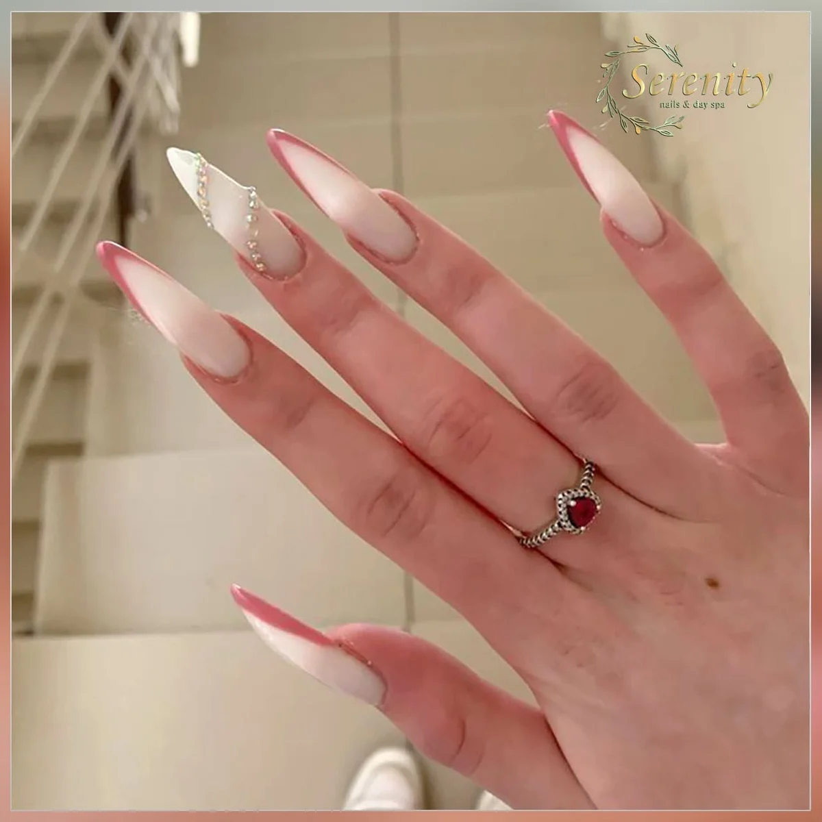 Blush French manicure with delicate gold details, from Serenity Nail & Spa