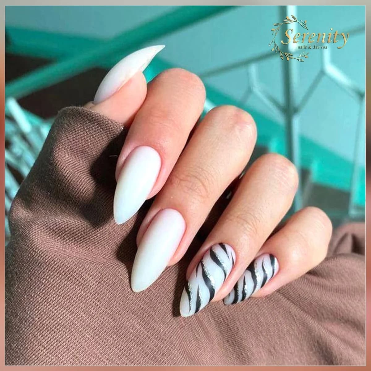 White almond nails with an accent design at Serenity